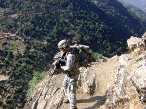 In this file photo dated 27 July, 2009, U.S. Army Staff Sgt. Clinton L. Romesha patrols near Combat Outpost Keating in Kamdesh, Nuristan province, Afghanistan. Former Staff Sgt. Romesha was awarded the Medal of Honor 11 Feb., 2013, for actions during the Battle of Kamdesh at COP Keating, Nuristan province, Afghanistan, 3 Oct., 2009. Romesha was a section leader with Bravo Troop, 3rd Squadron, 61st Cavalry Regiment, 4th Brigade Combat Team, 4th Infantry Division at the time of the battle. (DoD photo/Released)