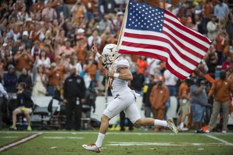 Boyer runs with the flag for the Texas Longhorns in final "Red River Shootout" in 2014.